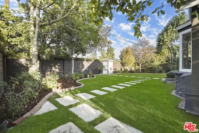 a view of a patio with couches chairs and wooden floor