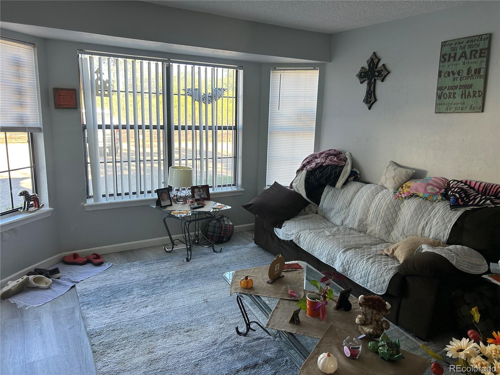 7980 Chase Circle, Unit F Arvada, CO 80003 - Photo 11 of 16 a living room with furniture and a window