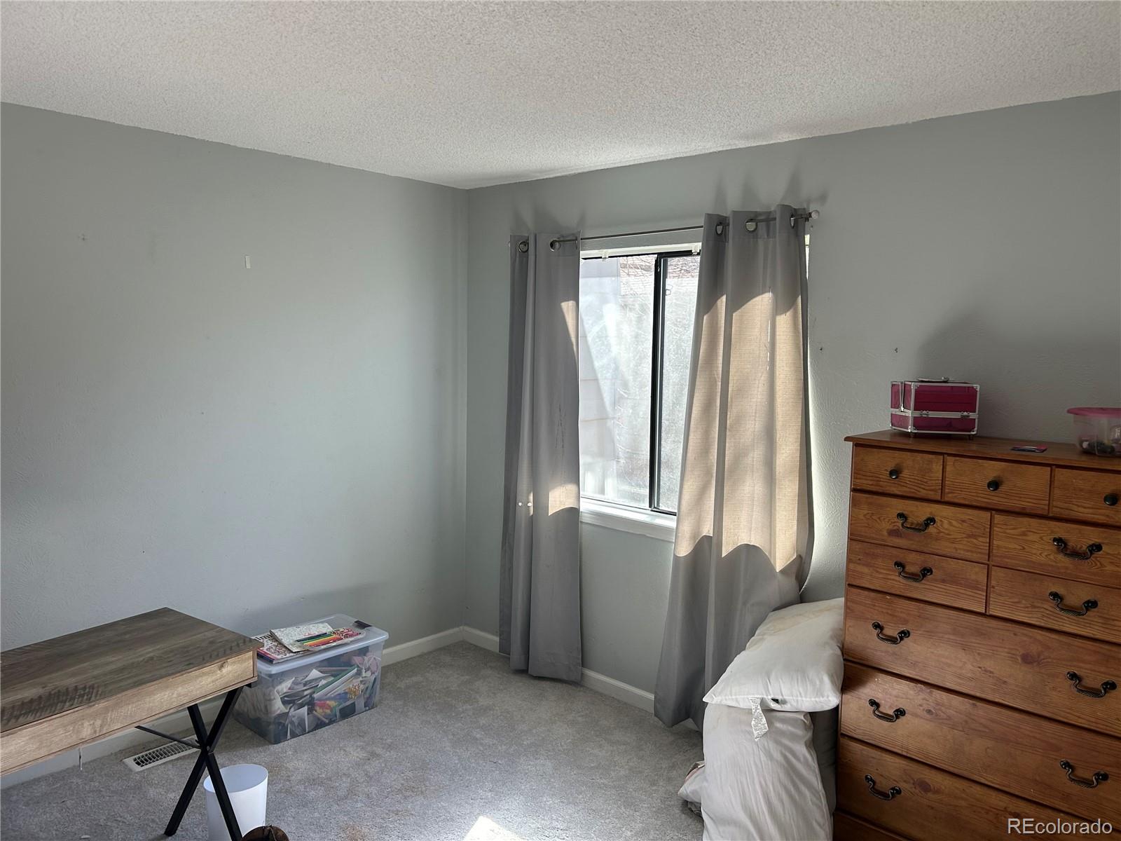 7980 Chase Circle, Unit F Arvada, CO 80003 - Photo 13 of 16 a room with a dresser and a window