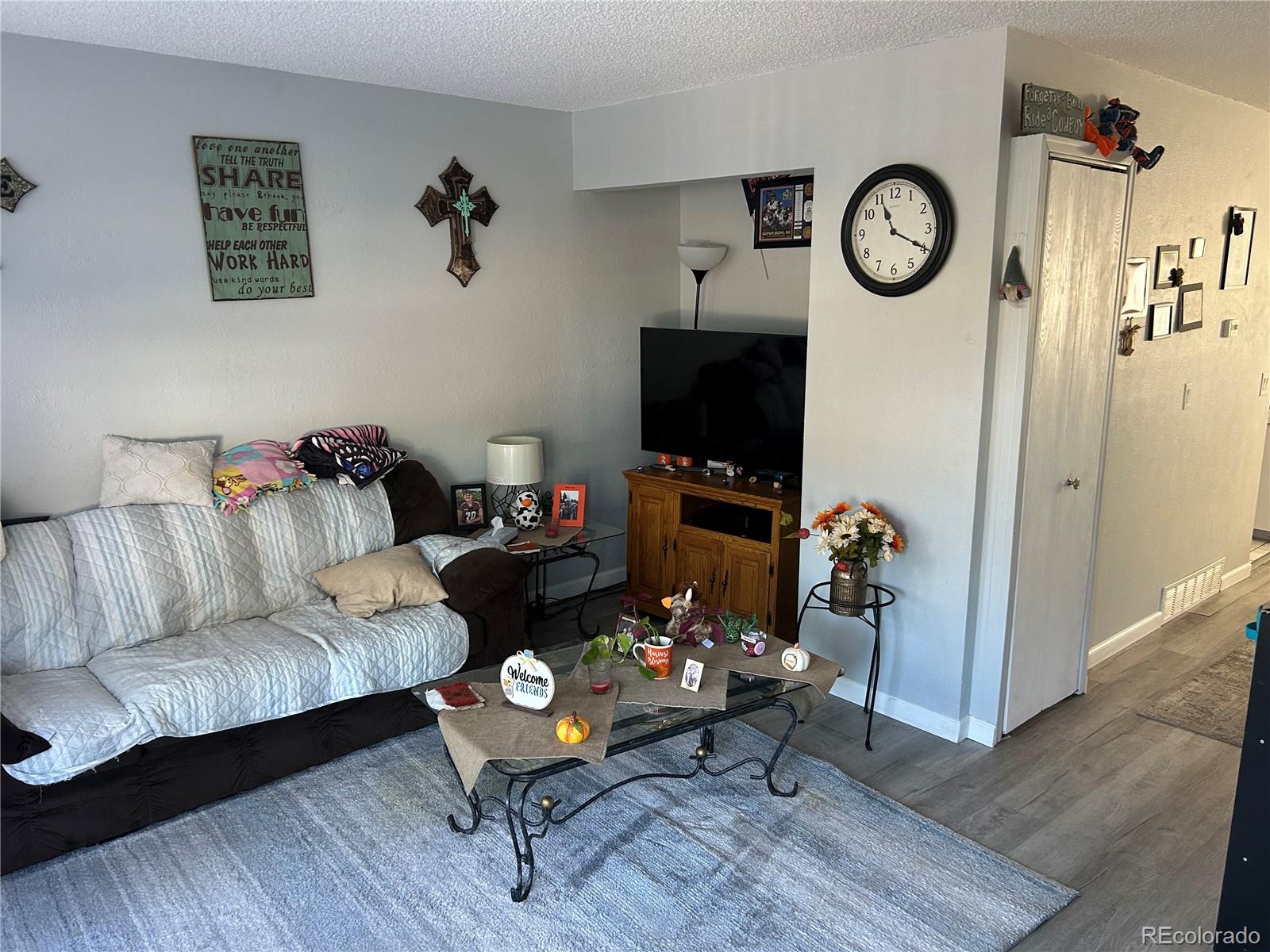 7980 Chase Circle, Unit F Arvada, CO 80003 - Photo 2 of 16 a living room with furniture and a flat screen tv