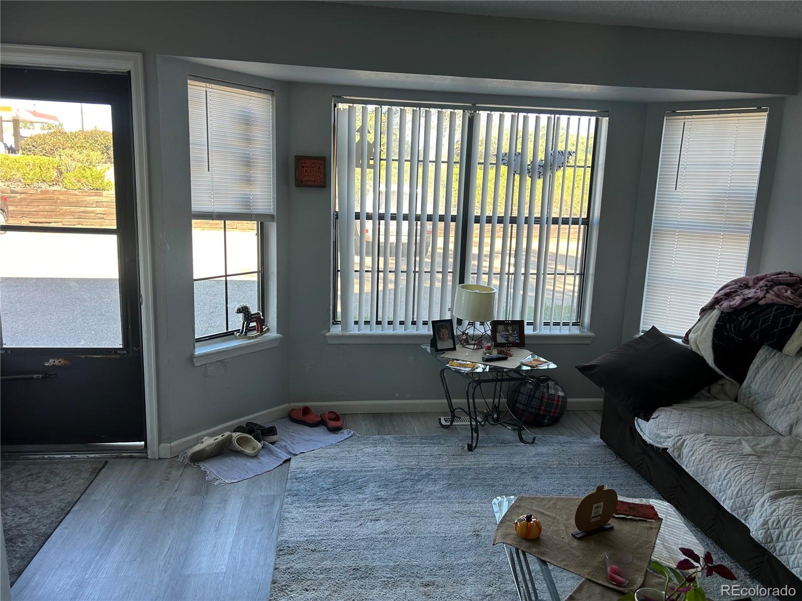 7980 Chase Circle, Unit F Arvada, CO 80003 - Photo 3 of 16 a living room with furniture and floor to ceiling window