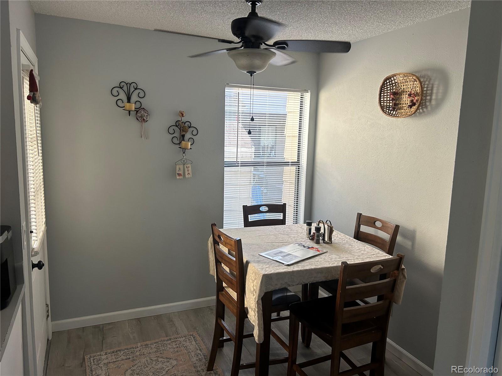 7980 Chase Circle, Unit F Arvada, CO 80003 - Photo 5 of 16 a view of a dining room that has a table and a chair in it