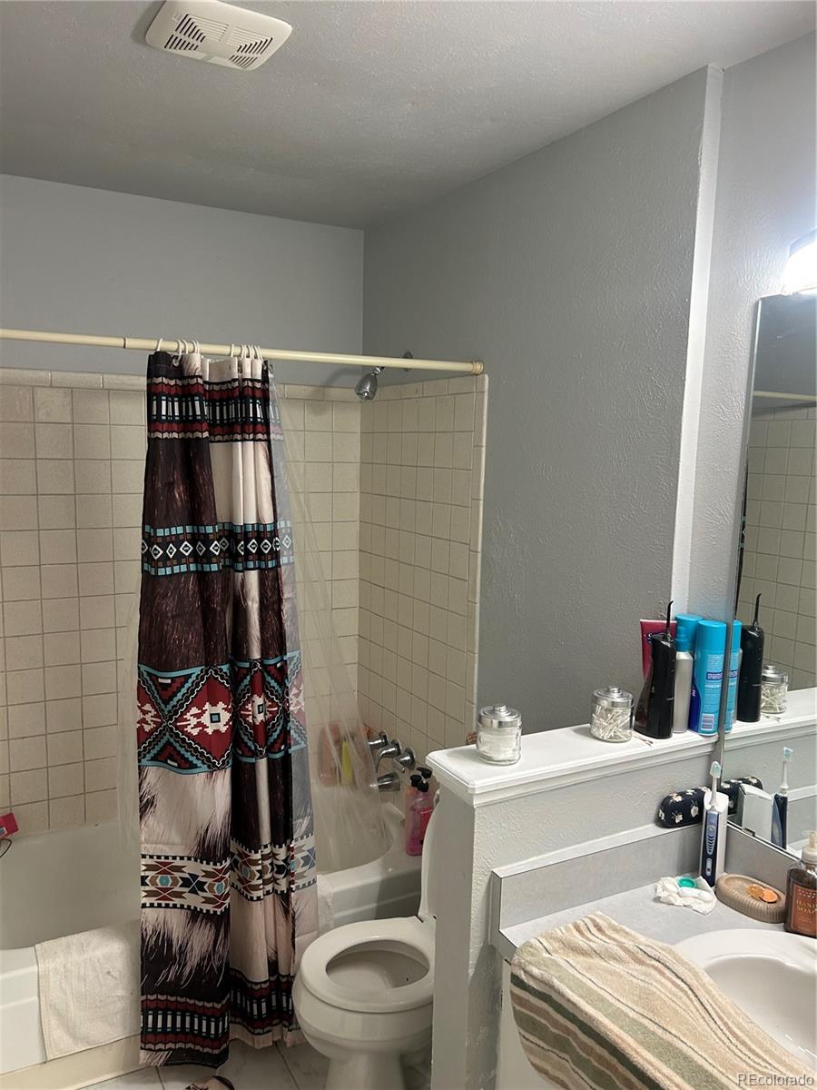 7980 Chase Circle, Unit F Arvada, CO 80003 - Photo 7 of 16 a bathroom with a sink toilet and shower