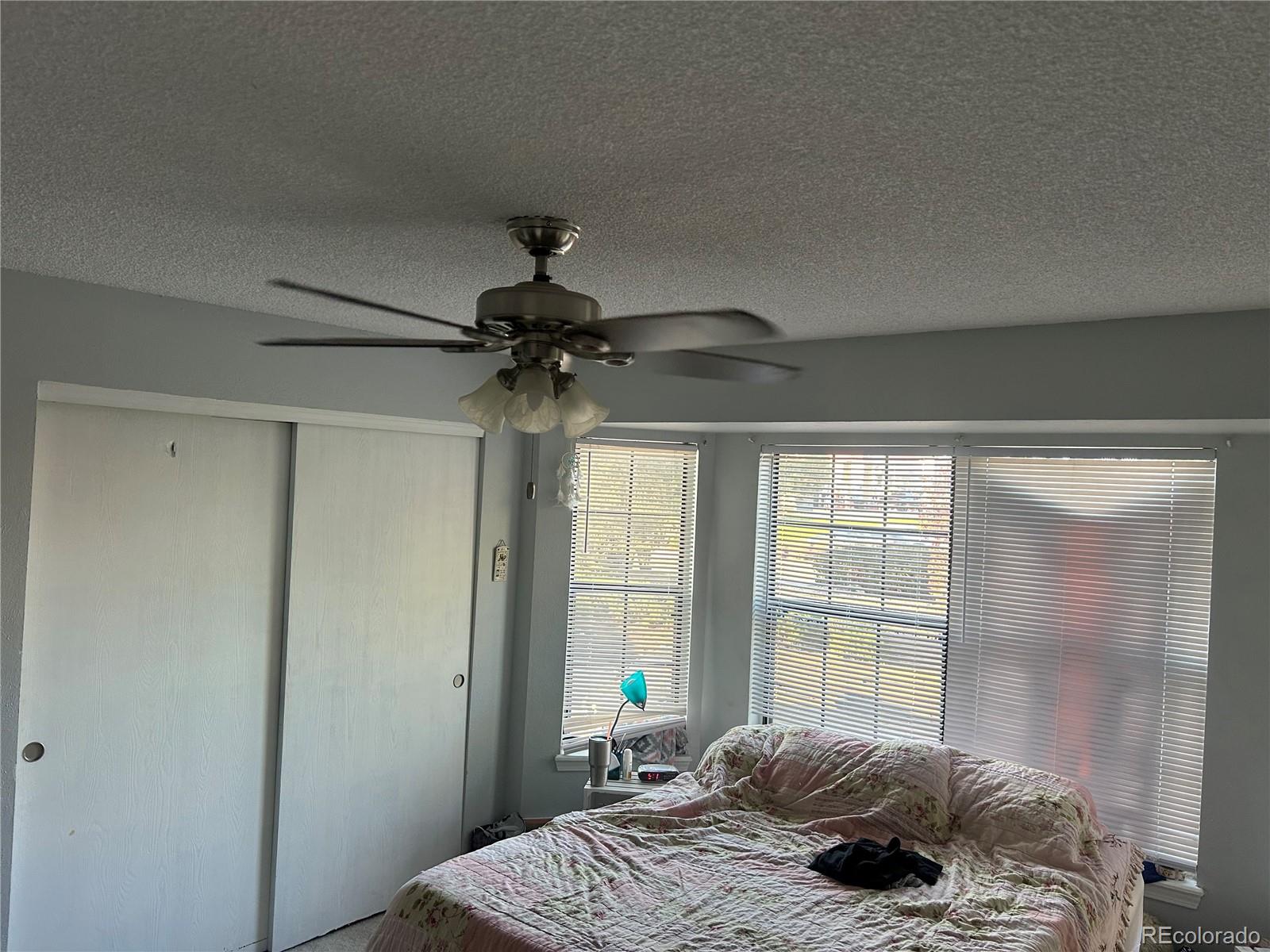 7980 Chase Circle, Unit F Arvada, CO 80003 - Photo 9 of 16 a bedroom with a bed and a window