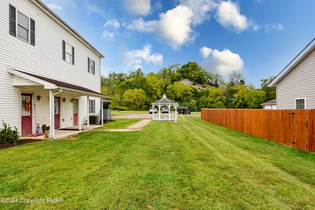 a swimming pool with outdoor seating and yard