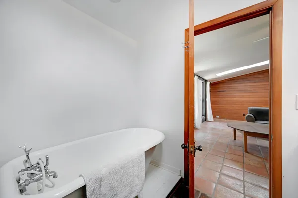 a bathroom with a bathtub and shower
