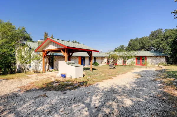 a front view of a house with a yard and seating area