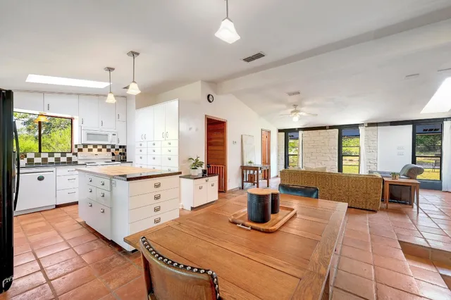 a kitchen with granite countertop a sink stainless steel appliances and cabinets