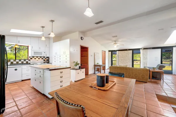 a kitchen with granite countertop a sink stainless steel appliances and cabinets