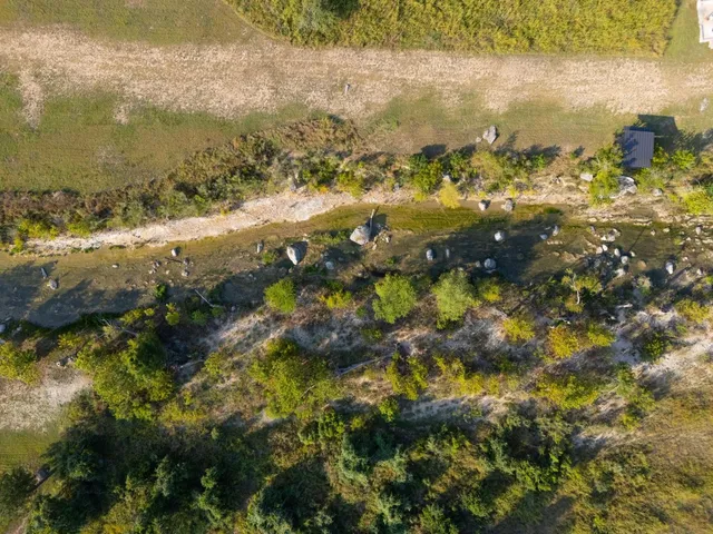 an aerial view of a house with a yard