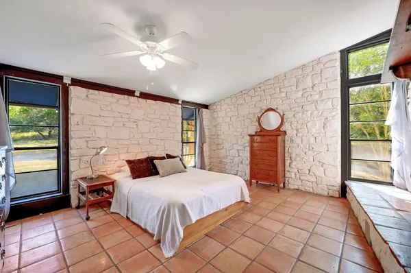 a view of an empty room with furniture and a window