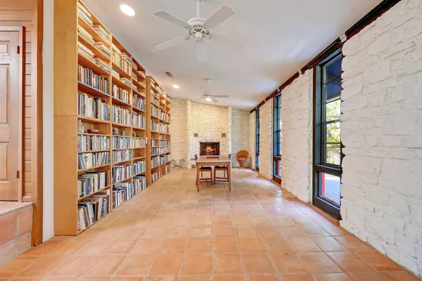 a living room with furniture and a book shelf
