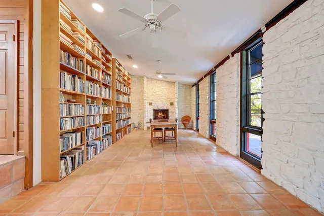 a living room with furniture and a book shelf