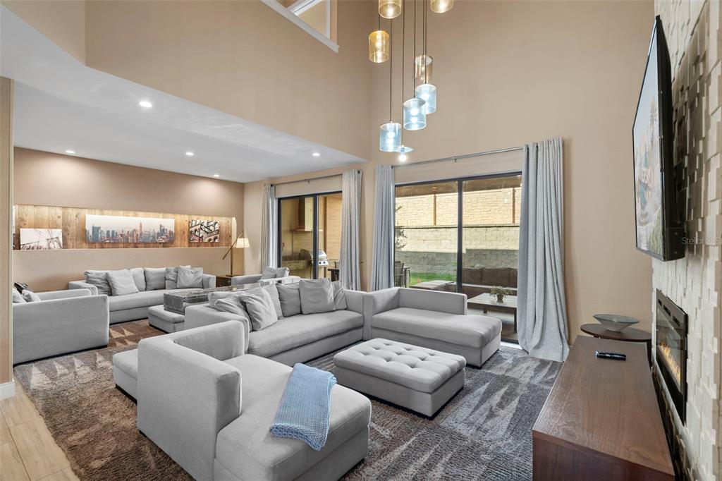 3099 Rockefeller Way Kissimmee, FL 34747 - Photo 11 of 54 a living room with furniture fireplace and a large window