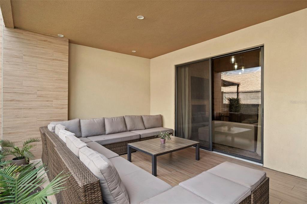 3099 Rockefeller Way Kissimmee, FL 34747 - Photo 17 of 54 a living room with furniture and a glass door