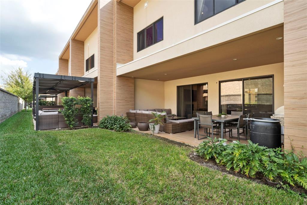 3099 Rockefeller Way Kissimmee, FL 34747 - Photo 18 of 54 a view of a house with a backyard and chairs
