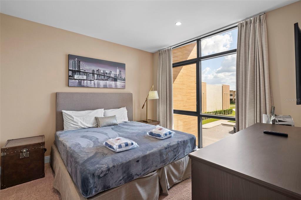 3099 Rockefeller Way Kissimmee, FL 34747 - Photo 22 of 54 a bedroom with a large bed and a desk