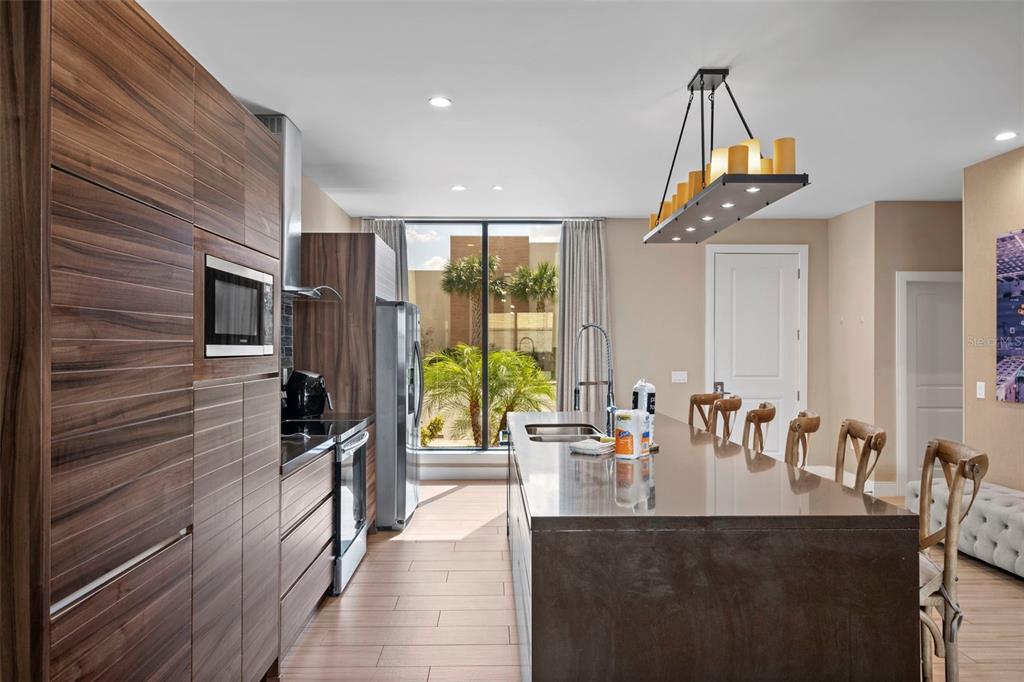 3099 Rockefeller Way Kissimmee, FL 34747 - Photo 6 of 54 a very nice looking dining room with a large window and chandelier