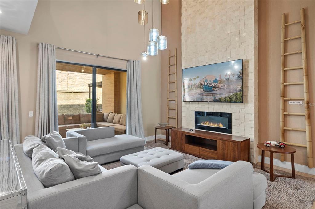 3099 Rockefeller Way Kissimmee, FL 34747 - Photo 9 of 54 a living room with furniture and a fireplace