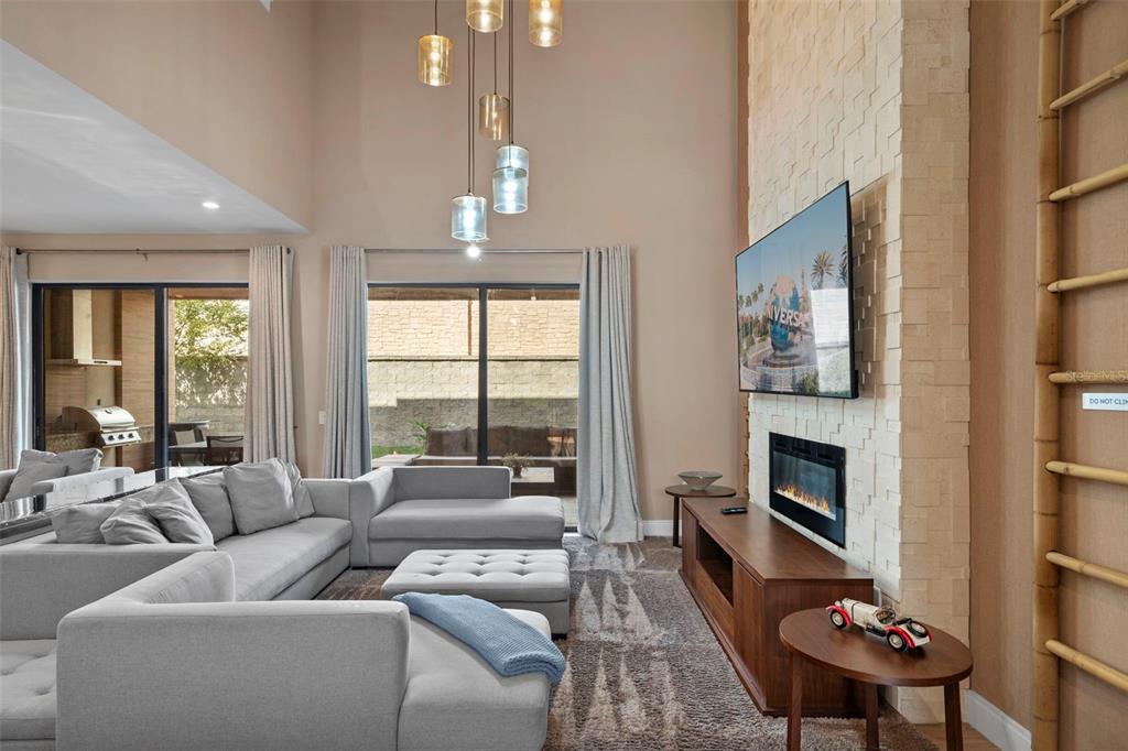 3099 Rockefeller Way Kissimmee, FL 34747 - Photo 10 of 54 a living room with furniture fireplace and a large window