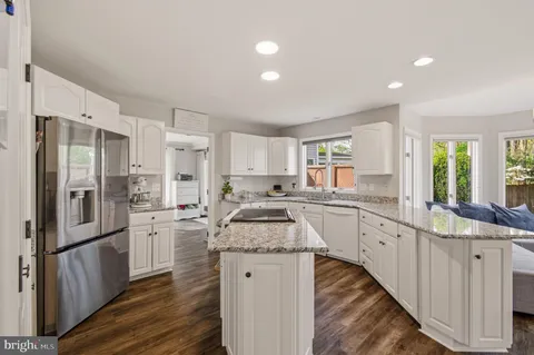 a living room with lots of furniture and kitchen view