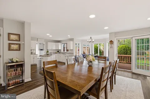 a living room with furniture kitchen view and a flat screen tv