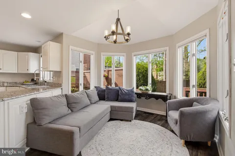 a view of a roof deck with table and chairs and wooden floor