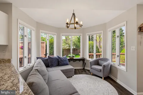 a view of balcony with chairs and wooden fence