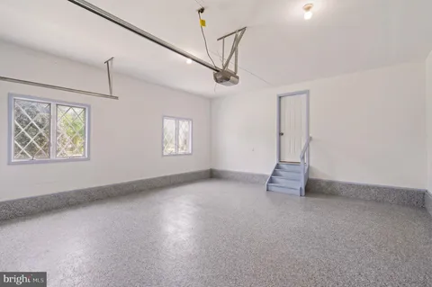 a bathroom with a tub a sink and a large mirror