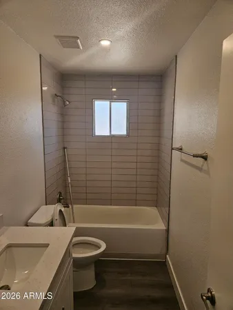 a view of storage and utility room with wooden floor