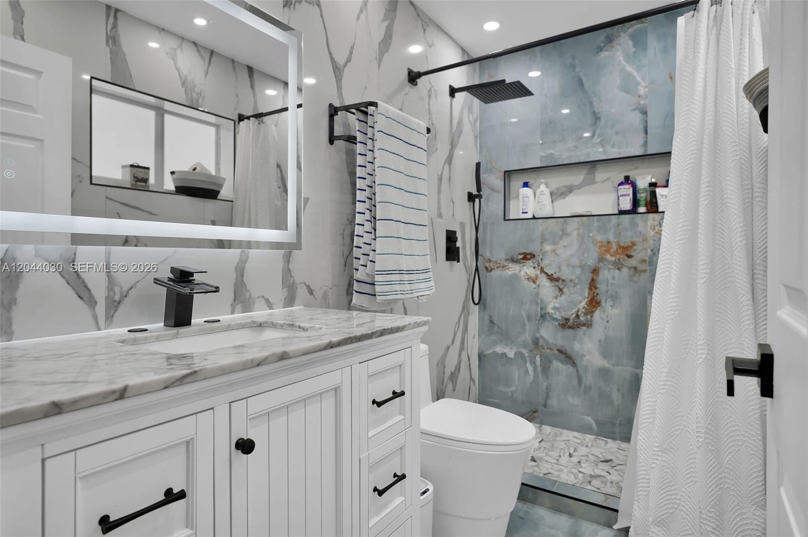 12551 Southwest 223rd Street Miami, FL 33170 - Photo 17 of 35 a bathroom with a granite countertop sink toilet and shower