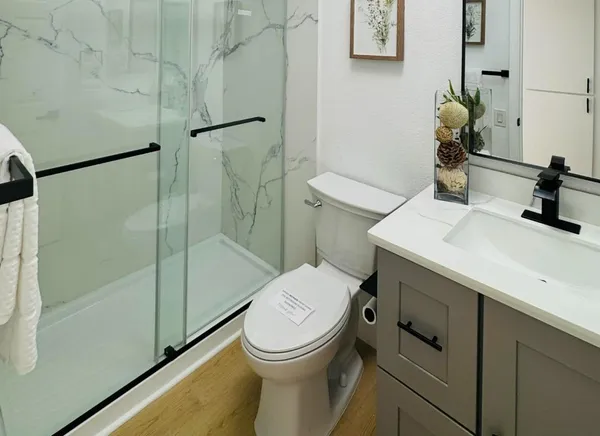a bathroom with a sink toilet and shower