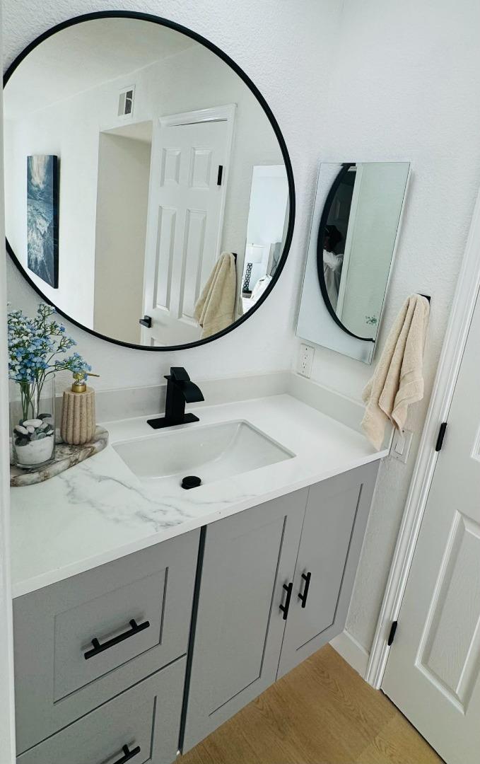 1213 Lightland Road San Jose, CA 95121 - Photo 14 of 16 a bathroom with mirror and vanity