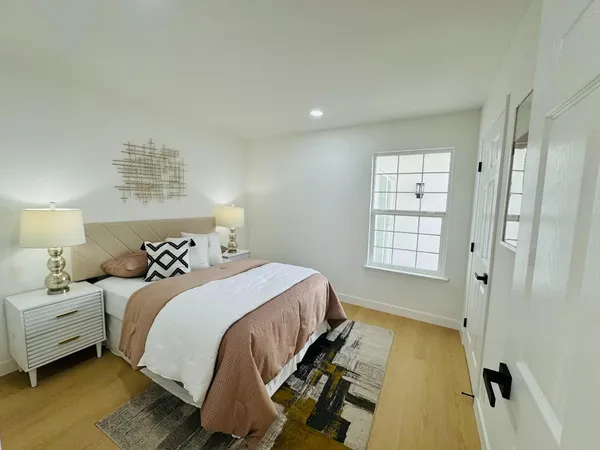 a bedroom with a bed and a window