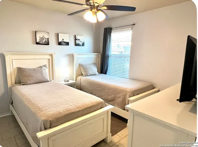 a bedroom with a bed and a flat screen tv