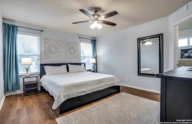 a bedroom with a large bed and a chandelier