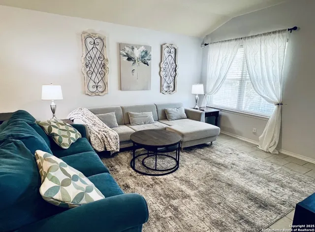 a living room with furniture and a large window