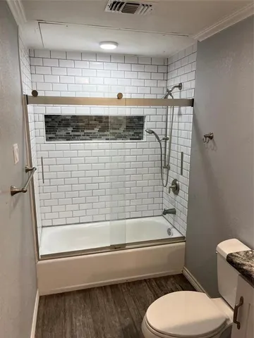 a bathroom with a toilet and a bathtub