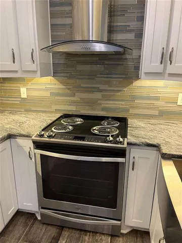 a stove top oven sitting inside of a kitchen