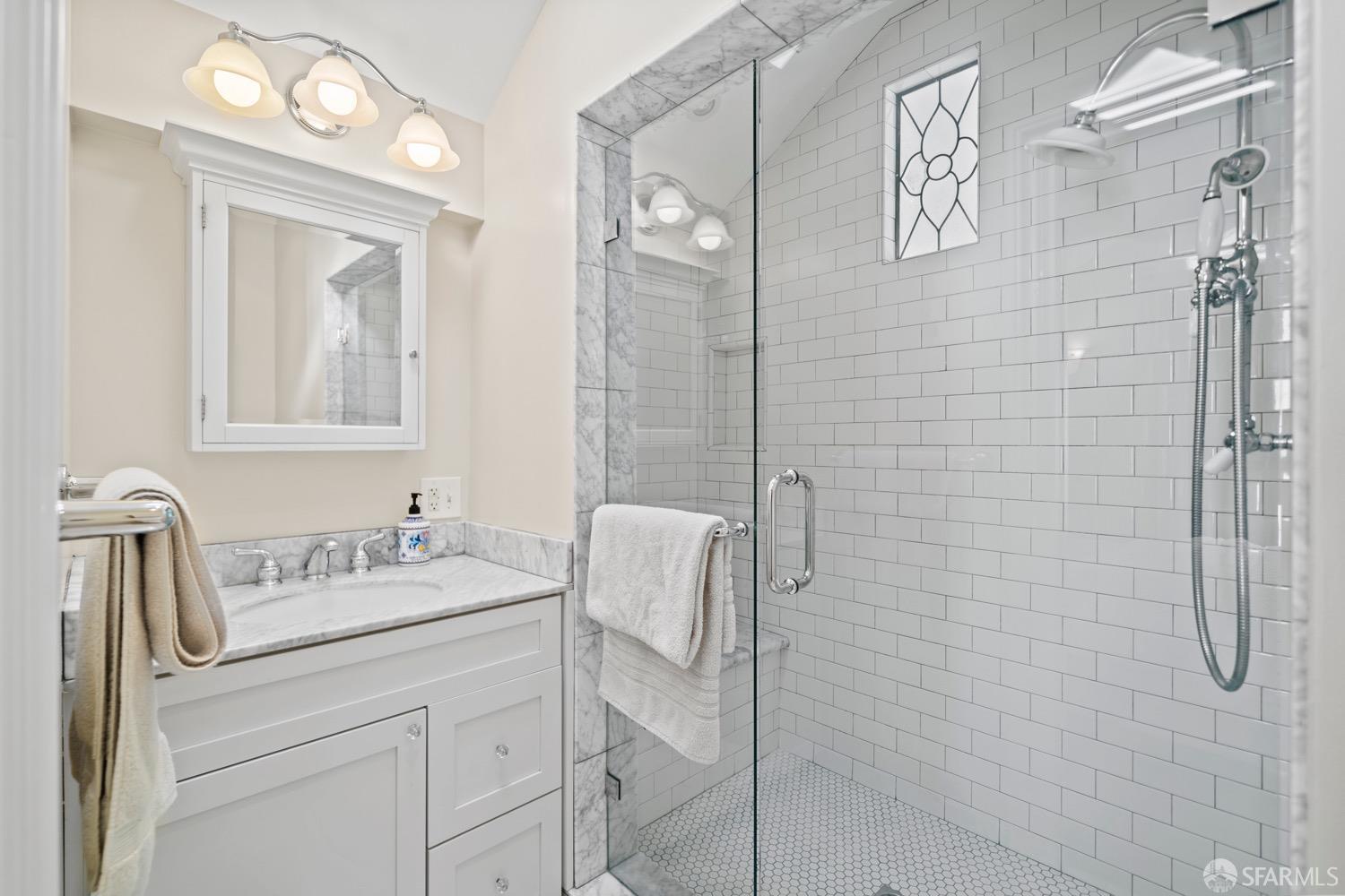 1 Cottage Row San Francisco, CA 94115 - Photo 14 of 52 a bathroom with a sink vanity granite and a mirror