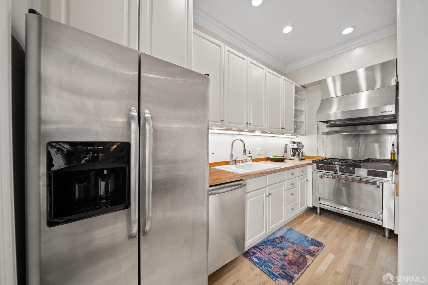 1 Cottage Row San Francisco, CA 94115 - Photo 23 of 52 a kitchen with stainless steel appliances granite countertop a refrigerator a sink and a stove
