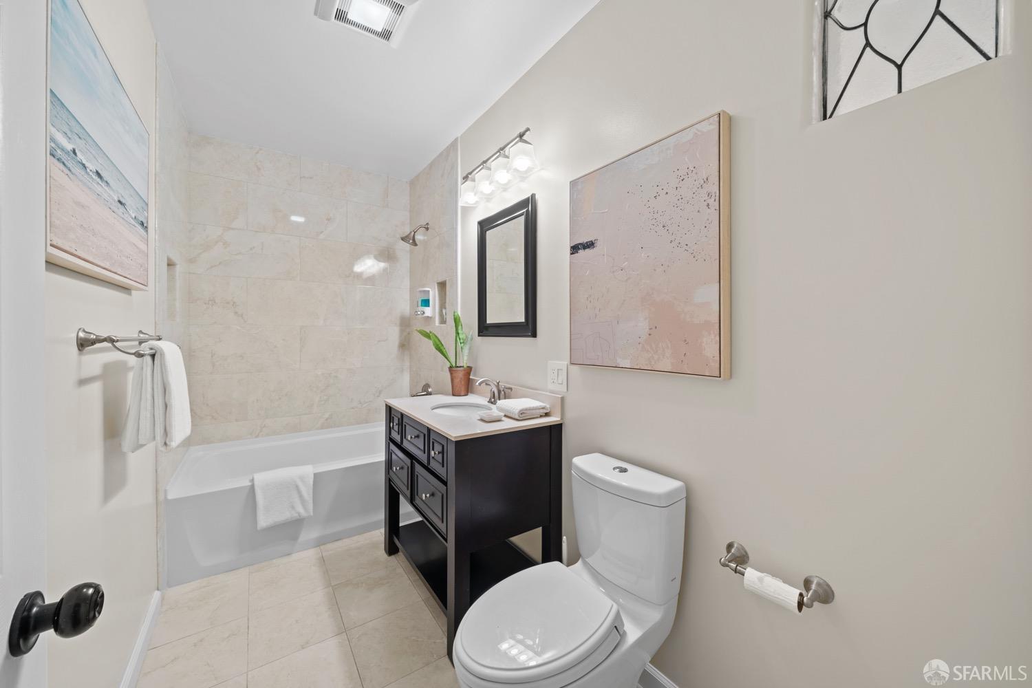 1 Cottage Row San Francisco, CA 94115 - Photo 30 of 52 a bathroom with a sink a toilet a mirror and shower