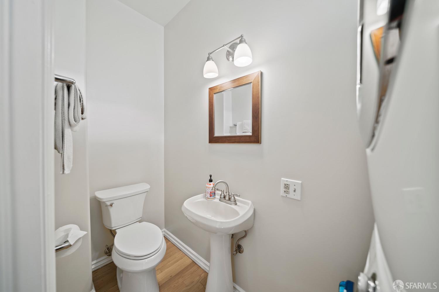 1 Cottage Row San Francisco, CA 94115 - Photo 31 of 52 a bathroom with a toilet a sink and mirror