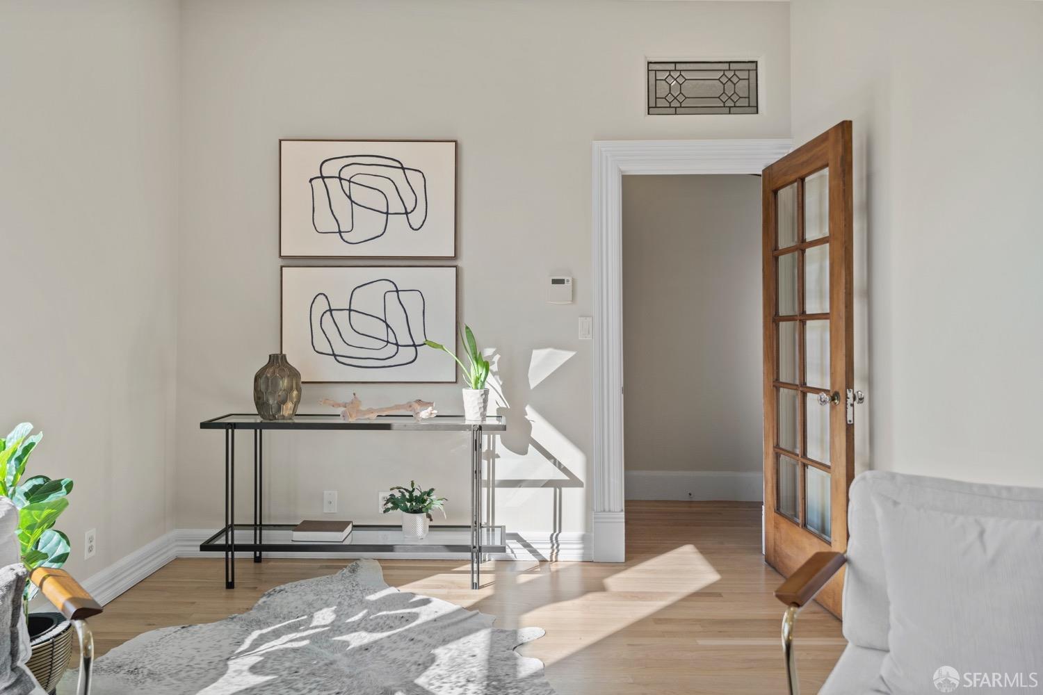 1 Cottage Row San Francisco, CA 94115 - Photo 9 of 52 a view of a hallway with paintings on the wall
