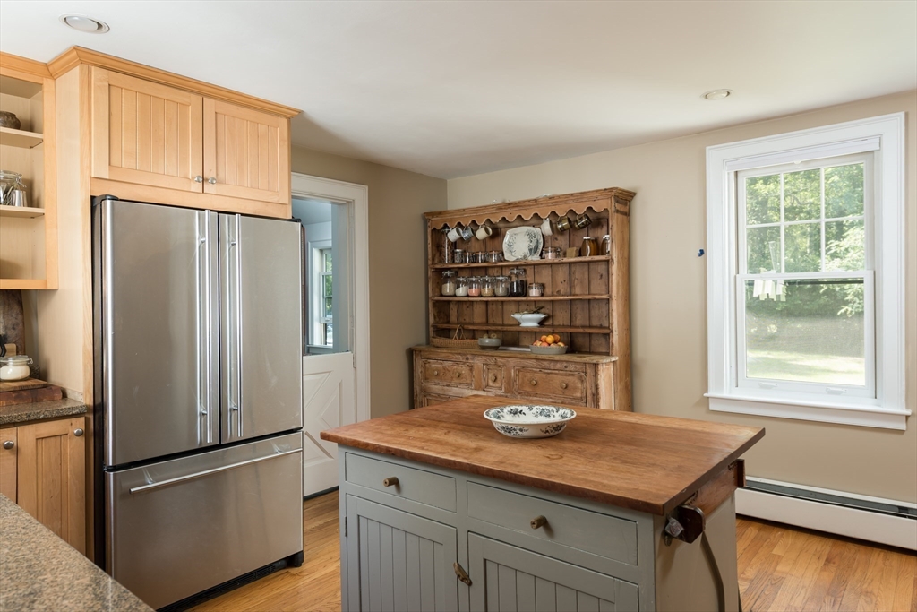 86 Fairhaven Road Mattapoisett, MA 02739 - Photo 11 of 40 a kitchen with a refrigerator and wooden floor