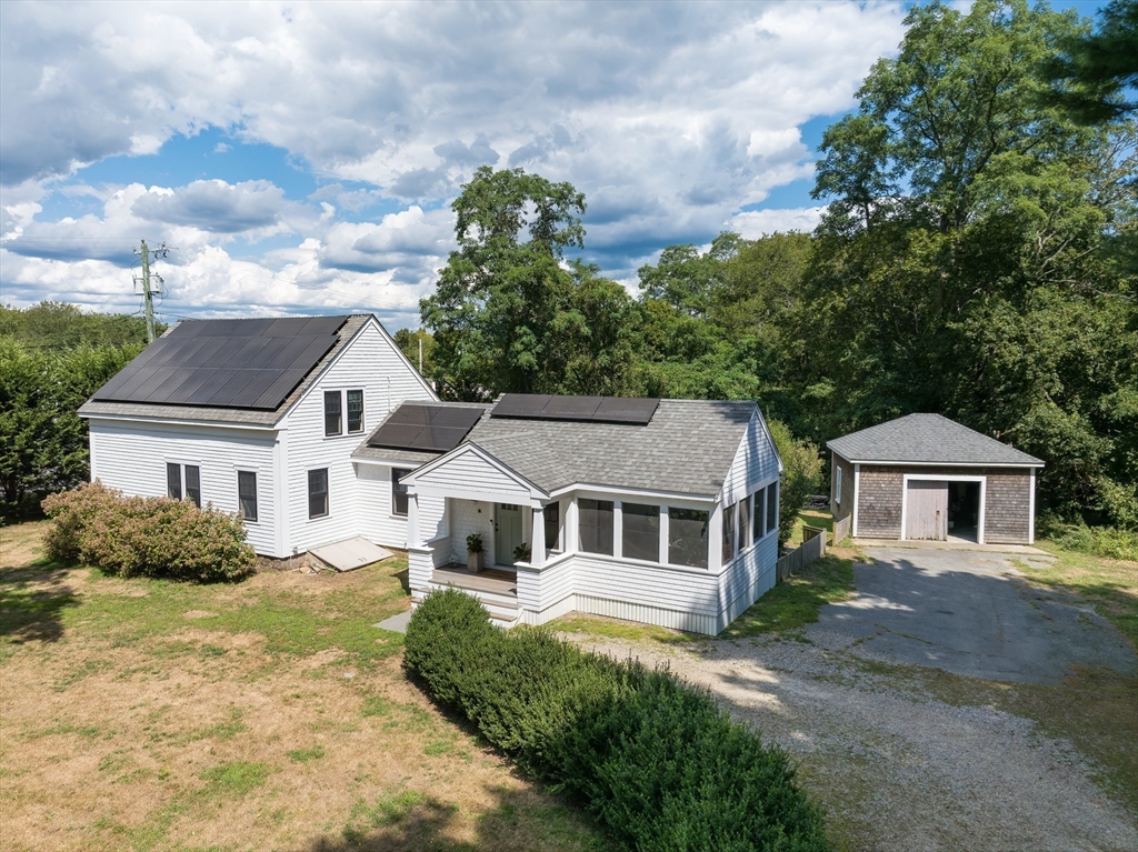 86 Fairhaven Road Mattapoisett, MA 02739 - Photo 2 of 40 a front view of a house with a garden