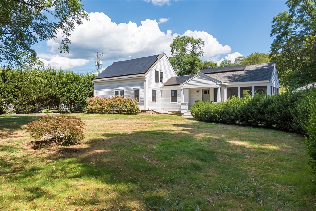 86 Fairhaven Road Mattapoisett, MA 02739 - Photo 25 of 40 a front view of a house with a garden