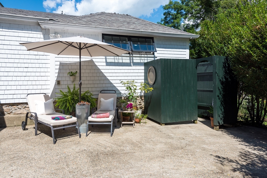 86 Fairhaven Road Mattapoisett, MA 02739 - Photo 29 of 40 a view of a patio with a table and chairs under an umbrella