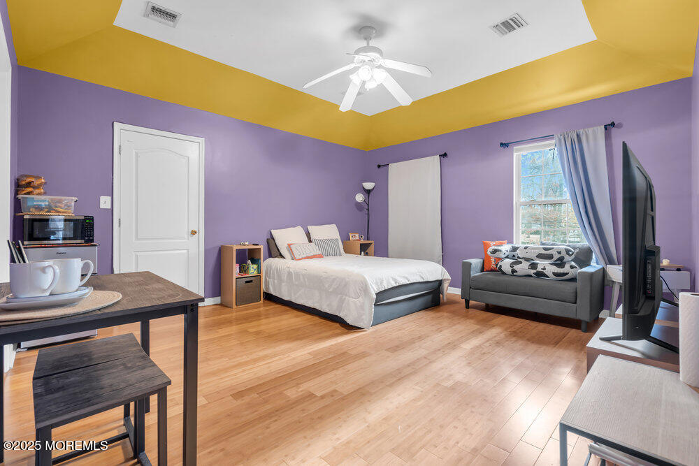 886 Green Valley Road Jackson, NJ 08527 - Photo 17 of 20 a bedroom with a bed and a flat screen tv