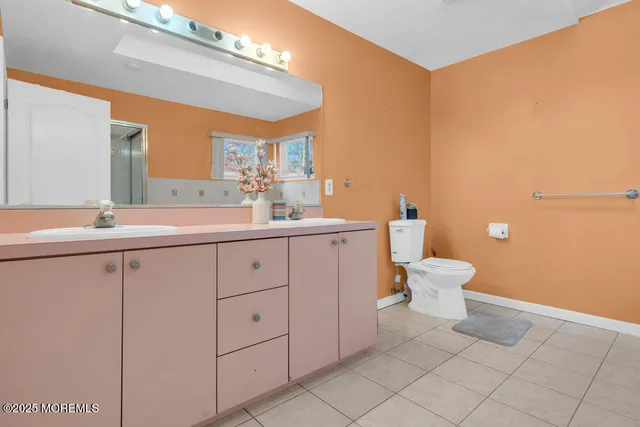 a view of bathroom with a sink mirror and toilet